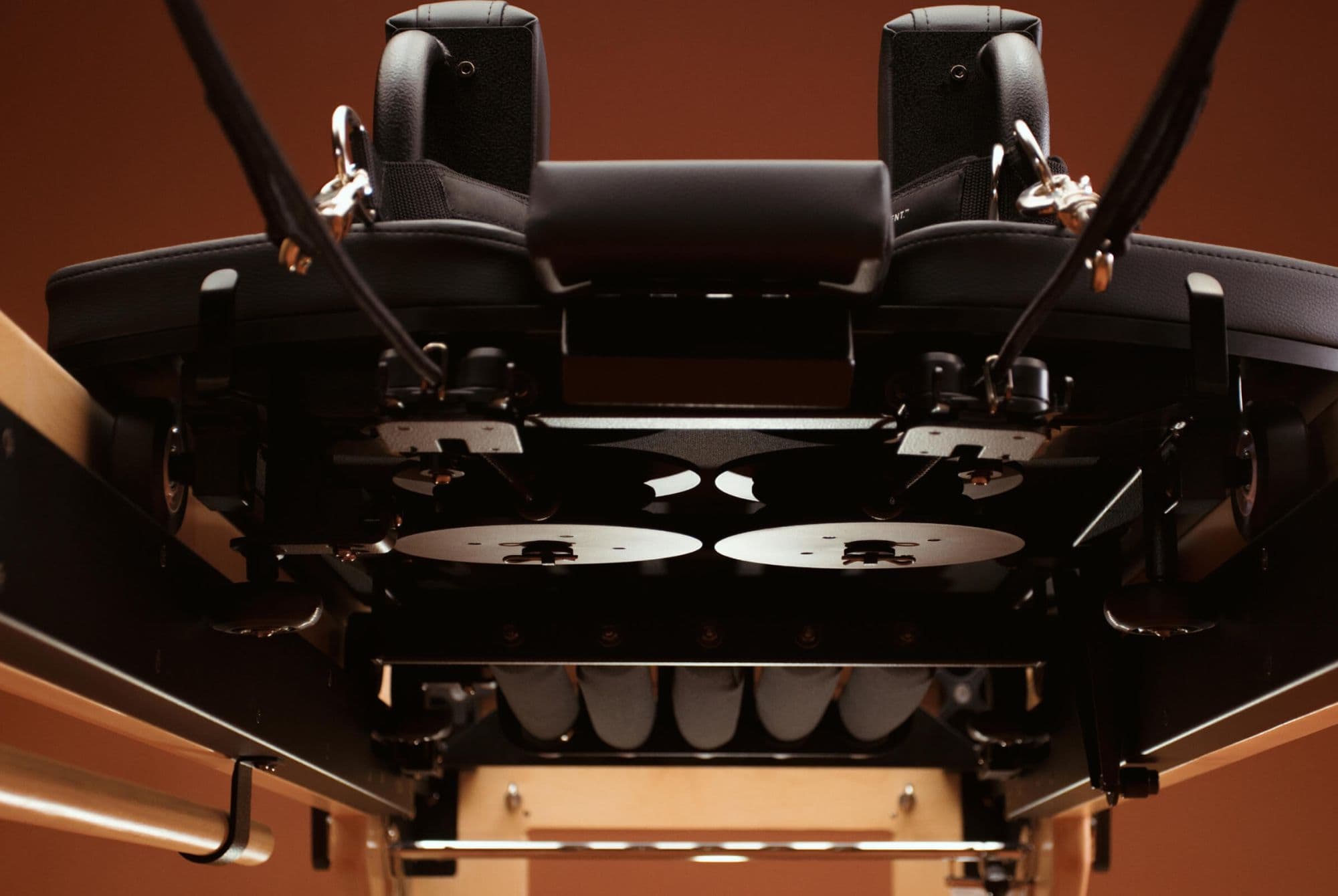 Underside of the NX3 MAX carriage showing wheels, pulleys and springs