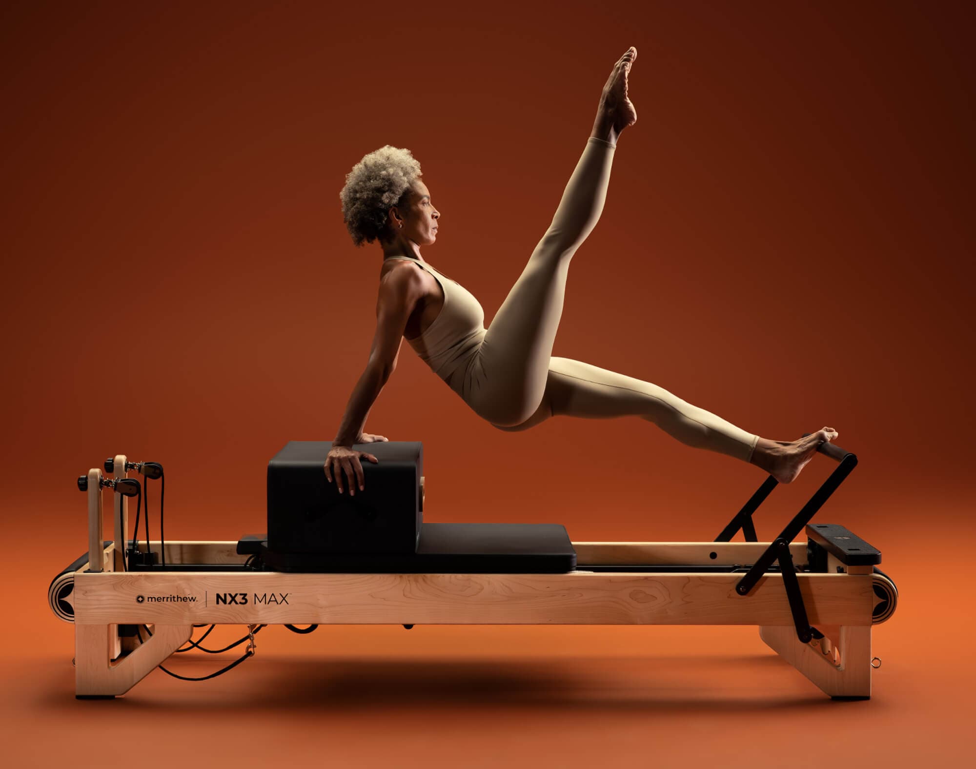 Athlete holding an advanced pose on the NX3 MAX with a sitting box